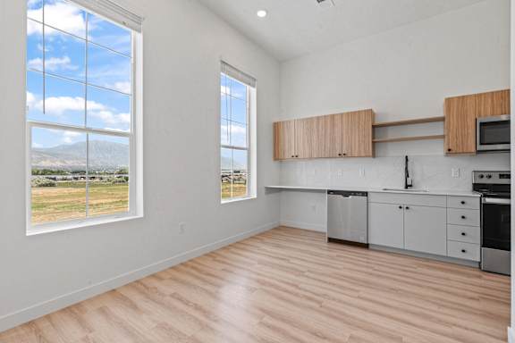 A kitchen with white cabinets and a microwave.