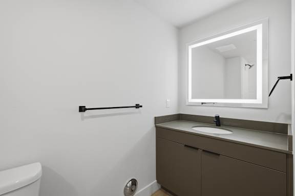 Bathroom with white sink and brown cabinet2 at Brickside Heights, Millcreek, UT, 84106