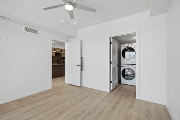 Room with ceiling fan and washing machine in the doorway at Brickside Heights, Millcreek, 84106