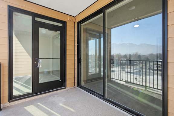 Balcony and glass door with black frame at Brickside Heights, Millcreek, UT, 84106
