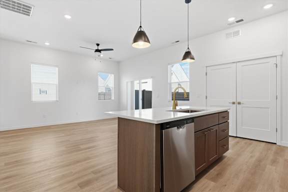 Wooden Island with hanging lights in Kitchen at Alante Homes at Spring Run, Caldwell, ID