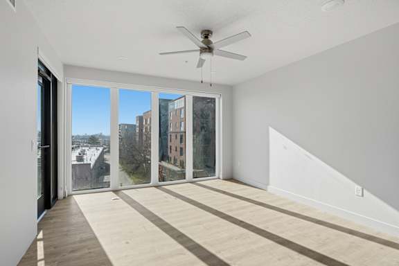 Room with ceiling fan and sliding glass doors at Brickside Heights, Millcreek, Utah