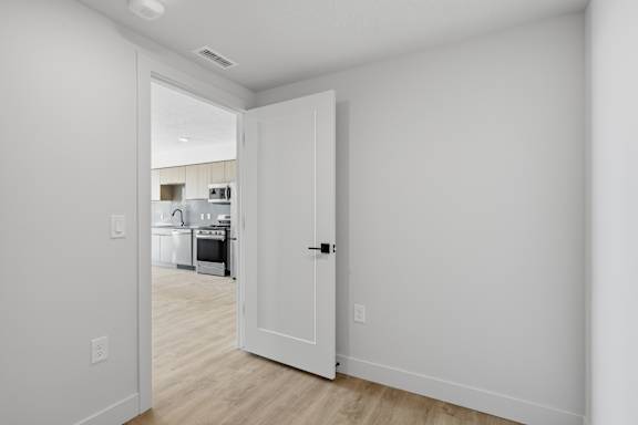 Room with open door at Brickside Heights, Millcreek