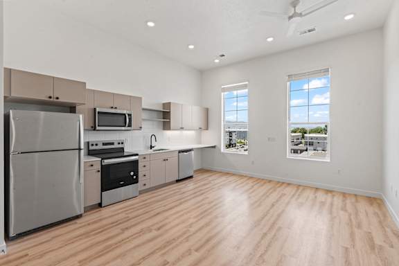 A kitchen with wooden floors and stainless steel appliances.