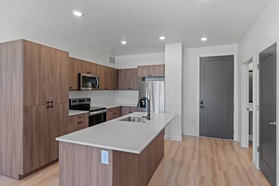 A kitchen with wooden cabinets and a white countertop.