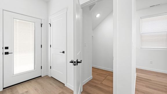 A white door with a black handle is on the left.at Alante Homes at Spring Run, Caldwell Idaho