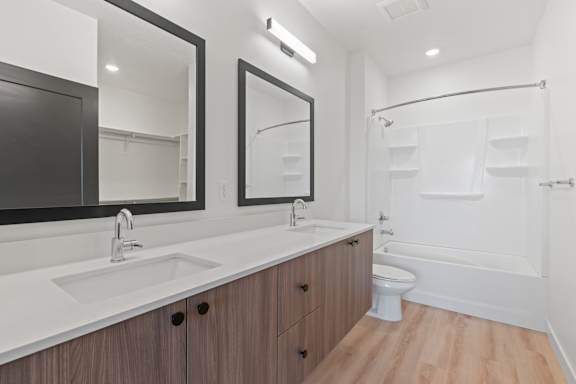 A bathroom with a white sink and a white toilet.