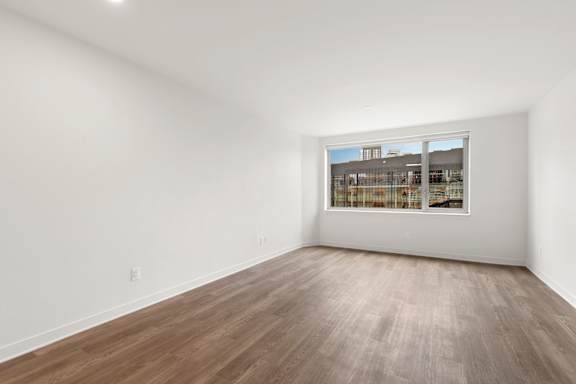 Large Empty room with wooden floor and white walls at AVIA on Pike Street, Seattle, Washington