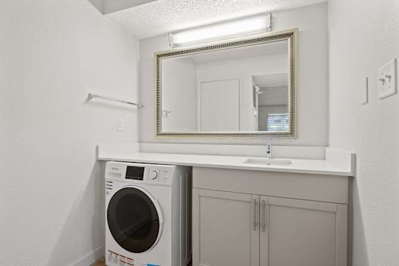 Small laundry room at AVIA Lofts on Liberty Ridge, Jacksonville, FL