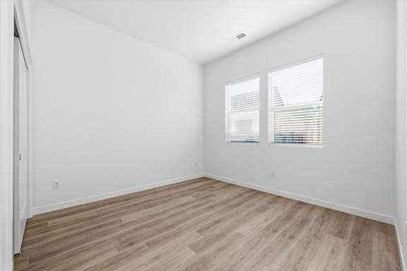 Wooden floor and window with natural light in a vacant room at Alante Homes at Spring Run, Caldwell, ID