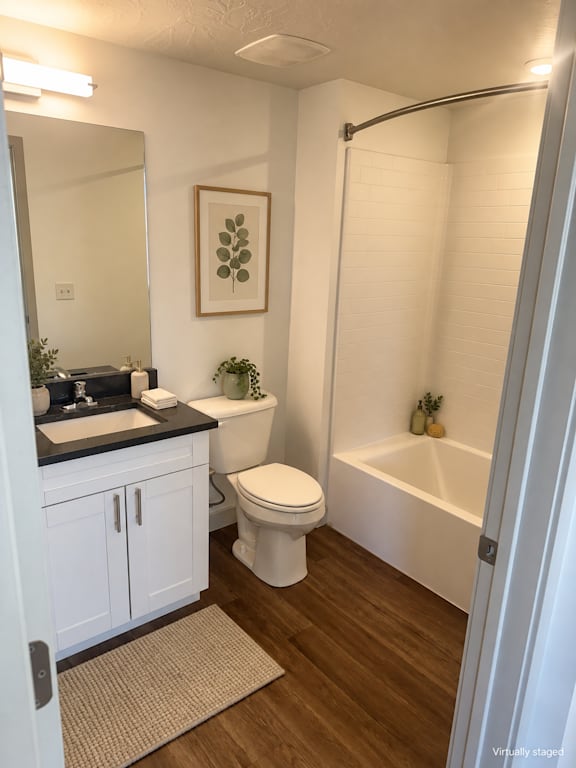 A white bathroom with a toilet, sink, and bathtub.