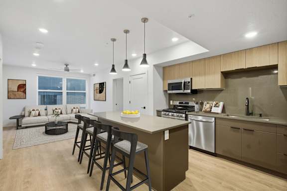 Modern Kitchen with large island and stools at Brickside Heights, Millcreek, UT