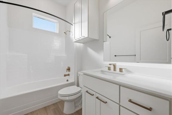 White bathroom with a toilet, sink, and a window at Alante Homes at Spring Run, Idaho