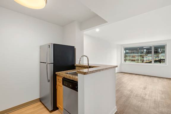 Bright Kitchen with Black Fridge and sink at AVIA on Pike Street, Seattle