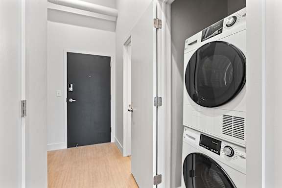 Modern machines in small laundry room at Brickside Heights, Millcreek, UT, 84106