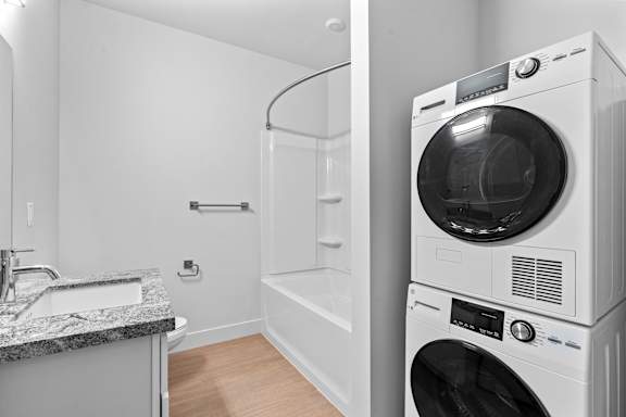White washing machine in laundry room at Brickside Heights, Millcreek
