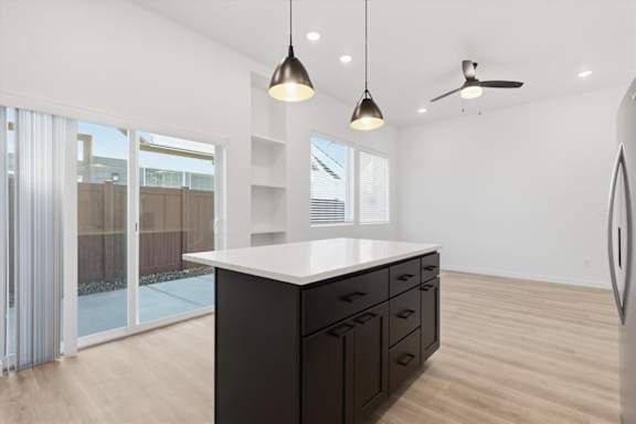 Modern kitchen with island and hanging lights at Alante Homes at Spring Run, Caldwell, ID