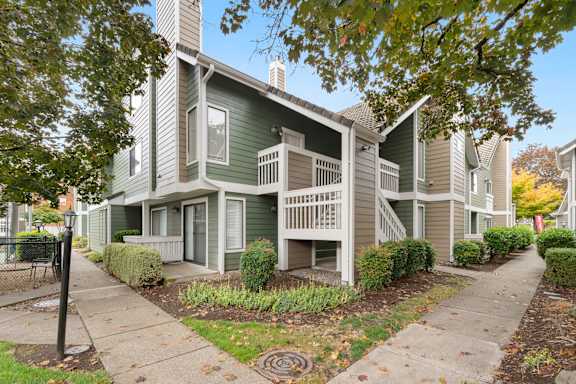 Apartment building with a green and beige exterior. at AVIA Lofts on Parkway, Vancouver Washington