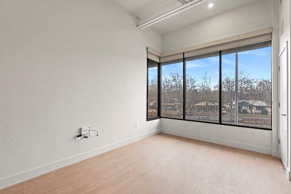 Large empty room with window at Brickside Heights, Utah