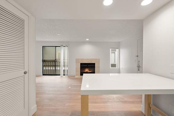 Room with table fireplace and sliding door at AVIA Lofts on Parkway, Vancouver Washington