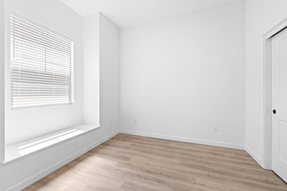 A room with a window and wooden flooring.at Alante Homes at Spring Run, Caldwell