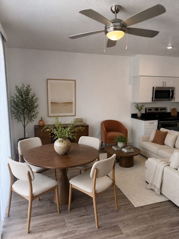 A dining room with a round table and chairs.
