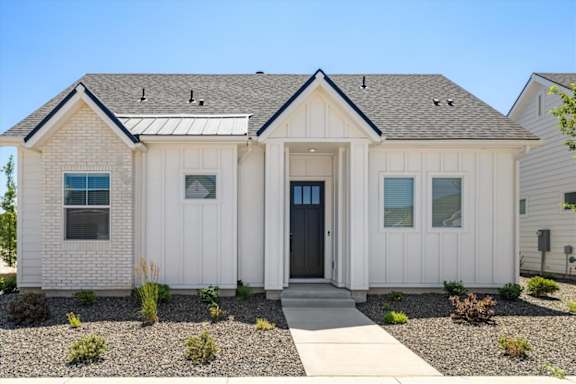 A white house with a black door and windows.
