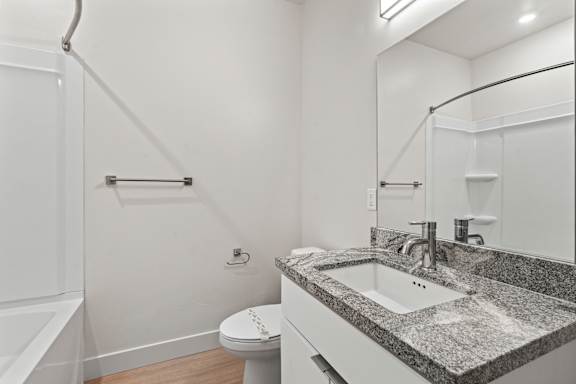 Bathroom with a toilet, sink, and shower at Brickside Heights, Millcreek, UT, 84106