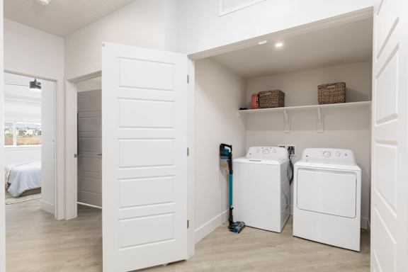 A white laundry room with a washer and dryer. at The Vue At Desert Color, St. George, 84790