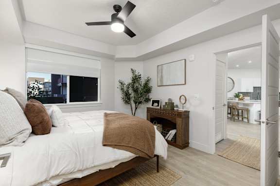 A bedroom with a large bed and a ceiling fan. at The Vue At Desert Color, St. George, 84790