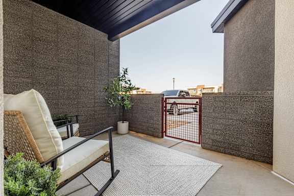 A patio with a chair and a table. at The Vue At Desert Color, St. George, Utah