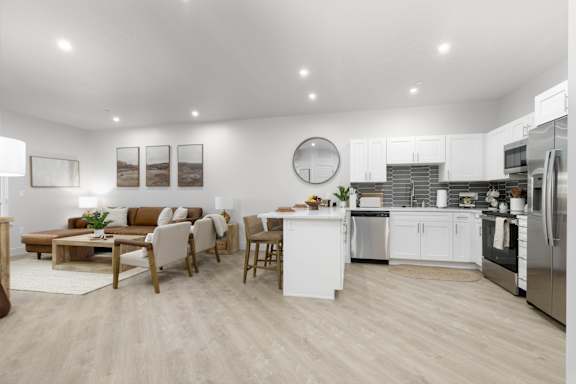A modern kitchen and living room with wooden floors at The Vue At Desert Color, St. George, UT, 84790