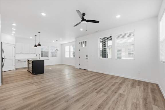 Spacious room with ceiling fan and wooden floor at Alante Homes at Spring Run, Caldwell, Idaho