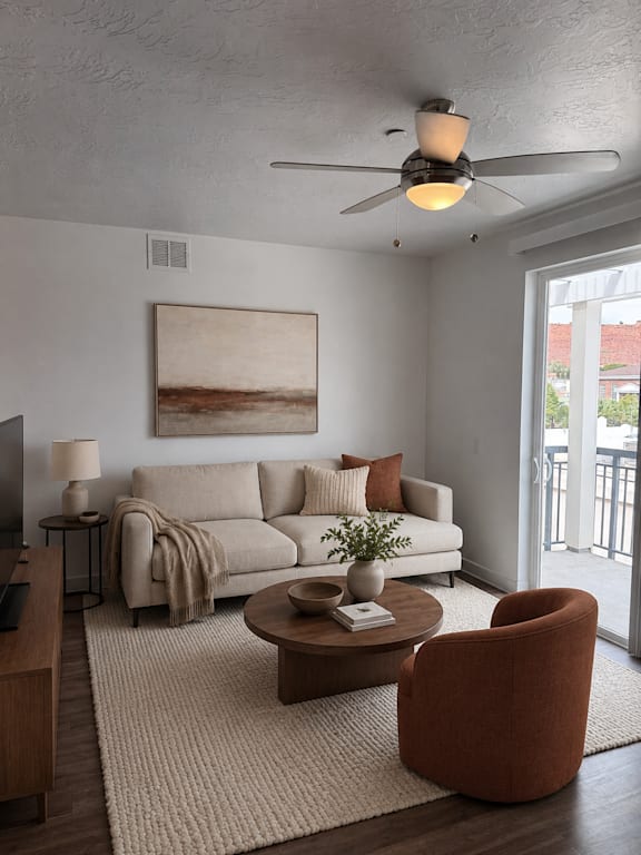 A living room with a couch, a chair, a coffee table, and a painting on the wall.