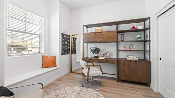 A room with a desk, chair, and shelves with various items.at Alante Homes at Spring Run, Caldwell, 83607