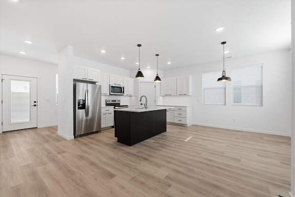 Spacious Kitchen with hanging lights and wooden floor at Alante Homes at Spring Run, Caldwell, ID