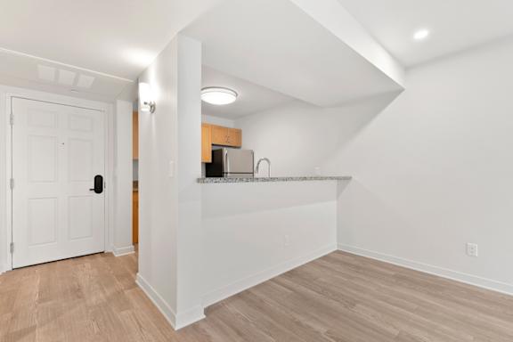 White kitchen with a wooden floor3 at AVIA on Pike Street, Seattle, 98101