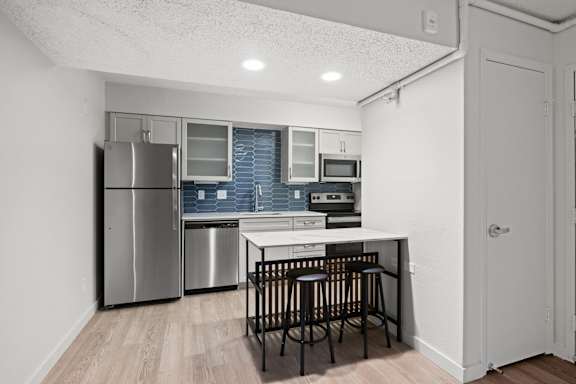Kitchen with a small table and chairs at AVIA Lofts on Liberty Ridge, Jacksonville