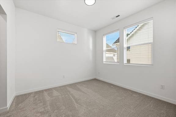 Carpeted room with multiple windows in a room at Alante Homes at Spring Run, Caldwell, Idaho
