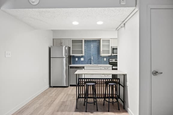 Kitchen with stainless steel refrigerator at AVIA Lofts on Liberty Ridge, Jacksonville, FL, 32256