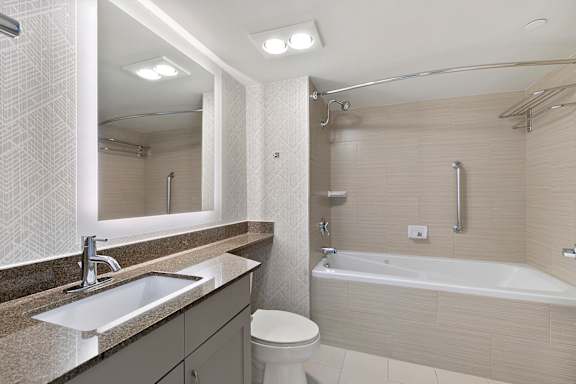 Bathroom with sink, toilet, and bathtub at AVIA on Pike Street, Seattle, Washington
