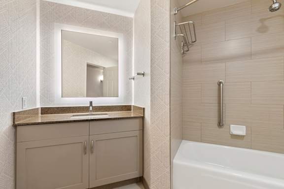 Bathroom with sink, mirror and bathtub1 at AVIA on Pike Street, Seattle