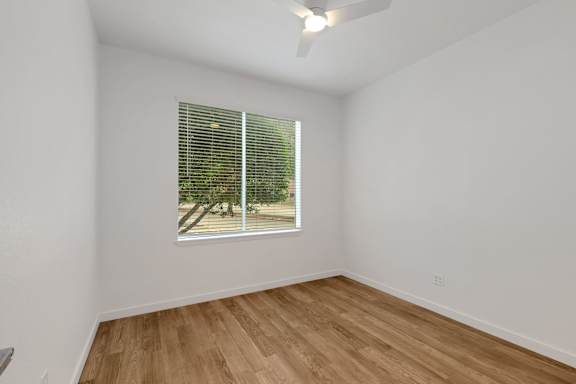 Room with wooden floor and ceiling fan4 at AVIA Apartments On Alpha, Texas