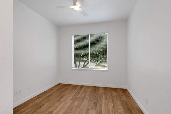Room with wooden floor and ceiling fan at AVIA Apartments On Alpha, Dallas, Texas