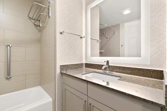 Bathroom with sink and mirror with light4 at AVIA on Pike Street, Seattle, WA, 98101