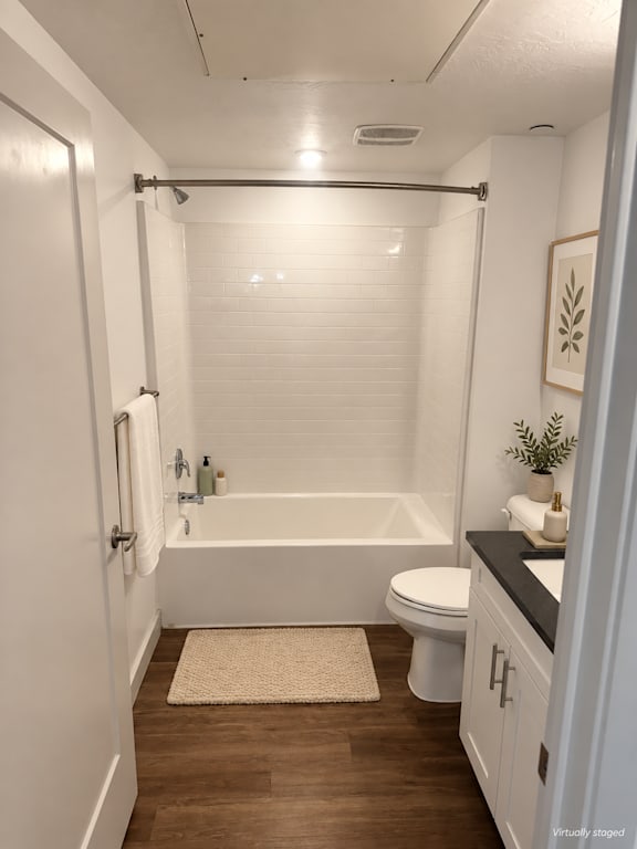 A white bathroom with a toilet, sink, and bathtub.