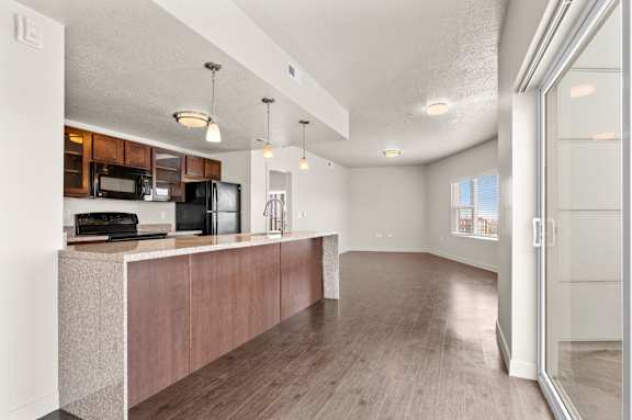 A kitchen with wooden cabinets and a countertop. at Wilmington Flats Apartments, Salt Lake City, 84106