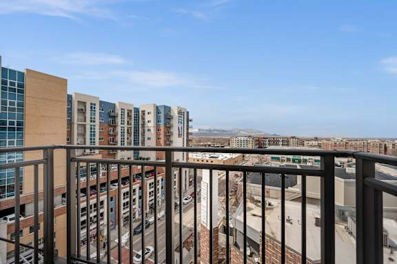 A view from a balcony overlooking a city street. at Wilmington Flats Apartments, Apartments, Salt Lake City, UT