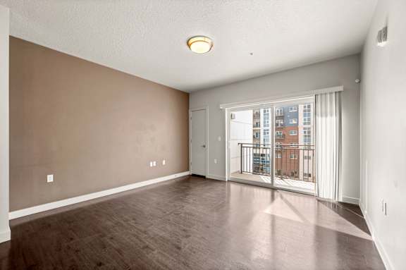 A room with a sliding glass door leading to a balcony. at Wilmington Flats Apartments, Salt Lake City, Utah
