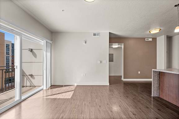 A spacious room with a sliding glass door leading to a balcony. at Wilmington Flats Apartments, Apartments, Salt Lake City, UT